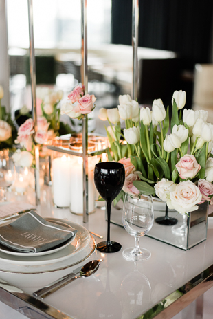 Lavelle Toronto Wedding Photography. Elegant rooftop experience in Toronto's King West neighbourhood. Wedding details photography of guest table settings with white and pink floral centerpieces, candles and white tableware. 