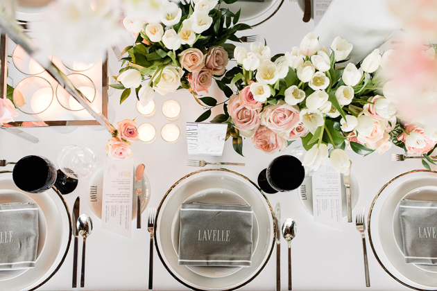 Lavelle Toronto Wedding Photography. Elegant rooftop experience in Toronto's King West neighbourhood. Wedding details photography of guest table settings with white and pink floral centerpieces, candles and white tableware. 