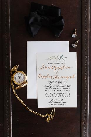 Toronto Wedding Photography. Groom outfit details, gold pocket watch, cuff links, black bow tie and wedding invitation card.