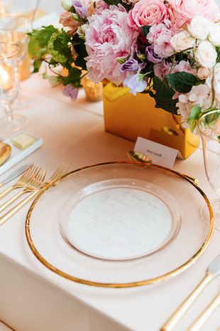 AGO Toronto Wedding Photography. Blush florals, gold accents and mauve table cloths create a sweet, elegant and stylish decor. Gold rimmed charger plates with gold cutlery.