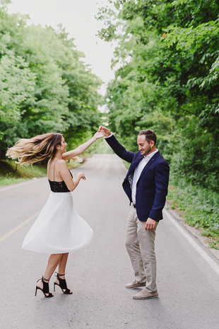 A beautiful couple dancing on the side road 