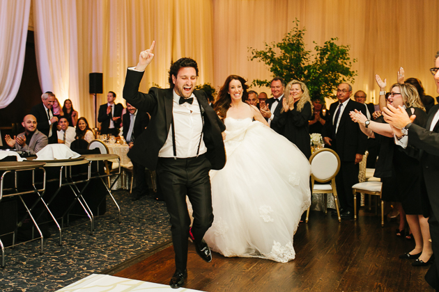 A bride and groom entering the wedding reception
