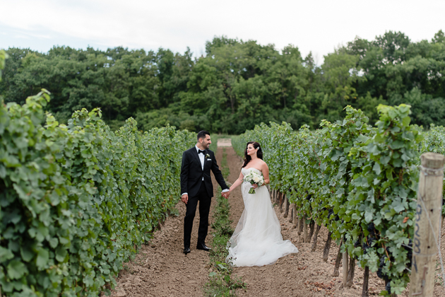 A bride and groom among the vineyards at Chateau Des Charmes