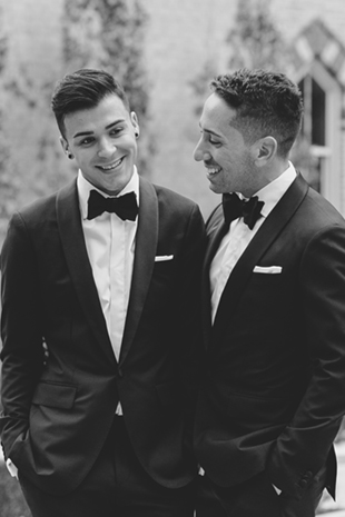 A classic black and white photo of grooms on their wedding day