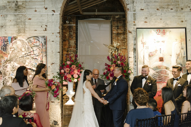 The bride and groom exchange their vows during their Thompson Landry Gallery wedding ceremony